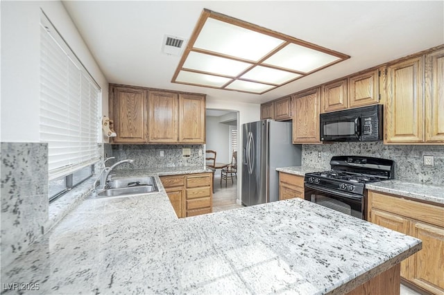 9021 Feather River Ct, Las Vegas, NV 89117 - kitchen with black appliances, backsplash, light stone countertops, and a peninsula