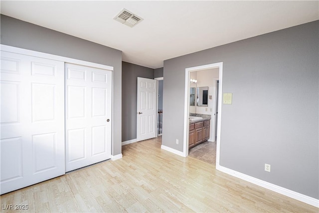 9021 Feather River Ct, Las Vegas, NV 89117 - unfurnished bedroom with light wood-style flooring, a closet, and ensuite bathroom
