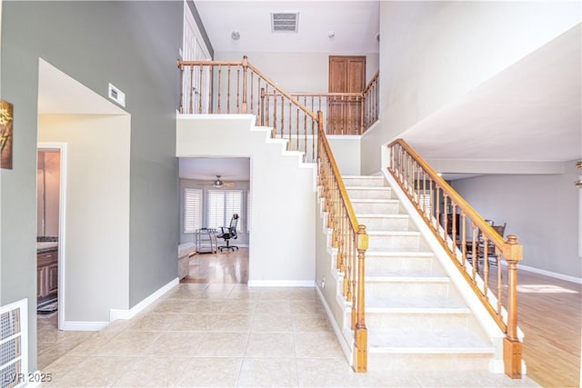 9021 Feather River Ct, Las Vegas, NV 89117 - staircase featuring a towering ceiling, tile patterned flooring, and a ceiling fan