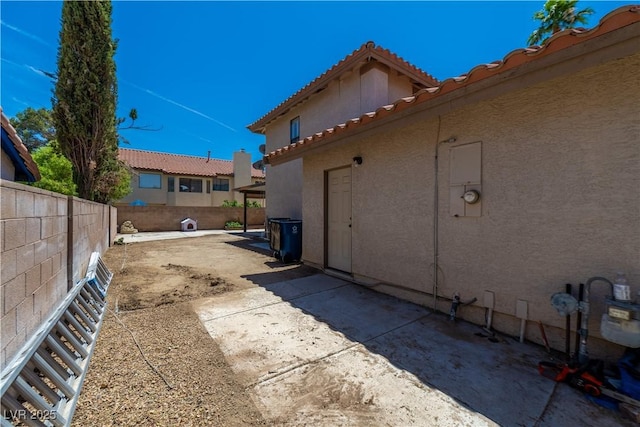 9021 Feather River Ct, Las Vegas, NV 89117 - view of side of property with stucco siding, a tile roof, and a patio area