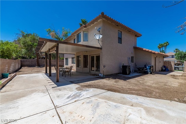 9021 Feather River Ct, Las Vegas, NV 89117 - rear view of house featuring a tile roof, a fenced backyard, stucco siding, and a patio