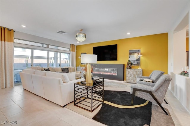 7208 Grace Estate Ave, Las Vegas, NV 89113 - tiled living area with a glass covered fireplace and recessed lighting