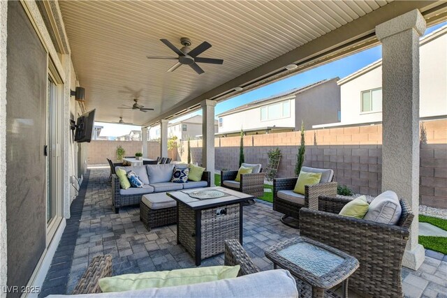 7208 Grace Estate Ave, Las Vegas, NV 89113 - fenced backyard featuring an outdoor living space with a fire pit, a patio, and a ceiling fan