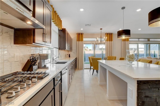 7208 Grace Estate Ave, Las Vegas, NV 89113 - kitchen featuring under cabinet range hood, stainless steel appliances, plenty of natural light, decorative backsplash, and recessed lighting