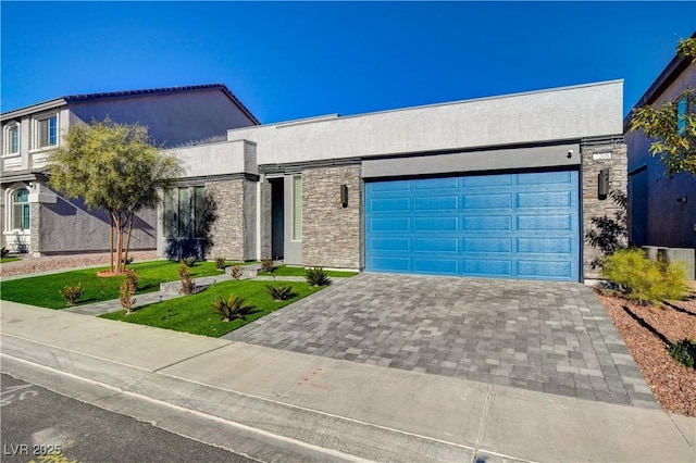 7208 Grace Estate Ave, Las Vegas, NV 89113 - contemporary house featuring an attached garage, decorative driveway, a front lawn, and stucco siding