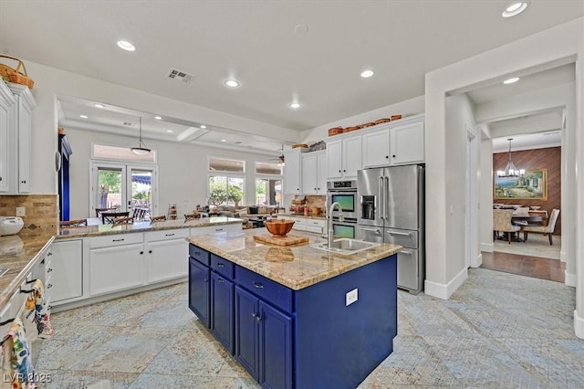 7408 Via Fiorentino St, Las Vegas, NV 89131 - kitchen featuring stainless steel appliances, blue cabinets, a peninsula, white cabinets, and recessed lighting