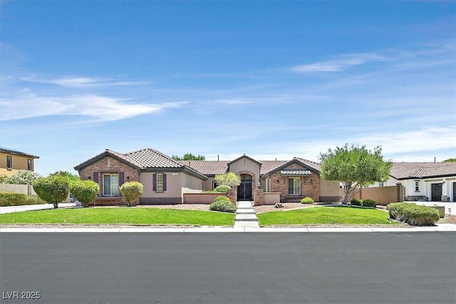 7408 Via Fiorentino St, Las Vegas, NV 89131 - view of front of home featuring a tiled roof, a front lawn, and stucco siding