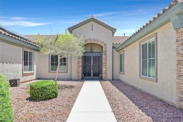 7408 Via Fiorentino St, Las Vegas, NV 89131 - doorway to property with stucco siding, french doors, and a tile roof