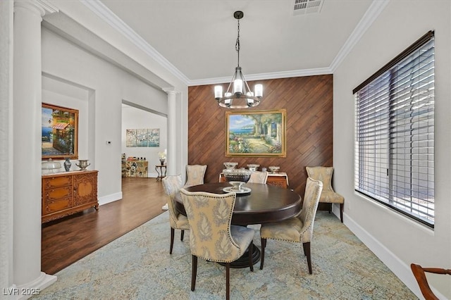 7408 Via Fiorentino St, Las Vegas, NV 89131 - dining room featuring decorative columns, crown molding, healthy amount of natural light, a chandelier, and wood walls