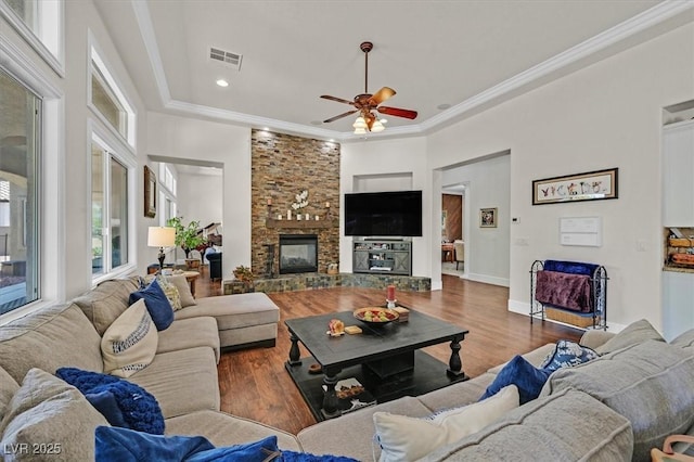 7408 Via Fiorentino St, Las Vegas, NV 89131 - living room featuring a ceiling fan, wood finished floors, a stone fireplace, ornamental molding, and recessed lighting