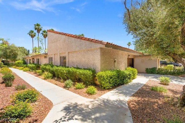2480 Domingo St, Las Vegas, NV 89121 - view of home's exterior with stucco siding and a tiled roof