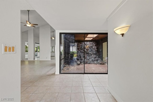 2480 Domingo St, Las Vegas, NV 89121 - tiled empty room featuring a ceiling fan and a fireplace