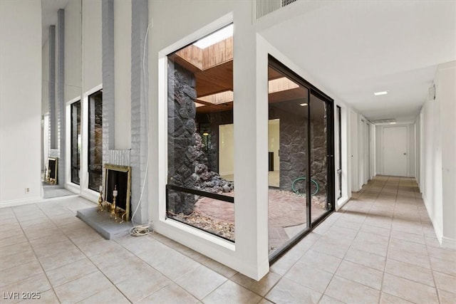 2480 Domingo St, Las Vegas, NV 89121 - hallway with light tile patterned floors, a high ceiling, and a skylight