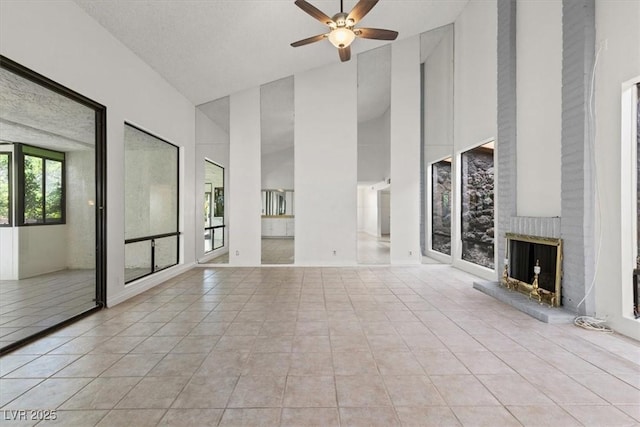 2480 Domingo St, Las Vegas, NV 89121 - unfurnished living room featuring high vaulted ceiling, a ceiling fan, tile patterned flooring, and a fireplace
