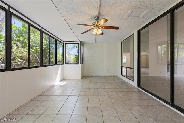 2480 Domingo St, Las Vegas, NV 89121 - unfurnished sunroom featuring a ceiling fan, tile patterned floors, expansive windows, and a textured ceiling