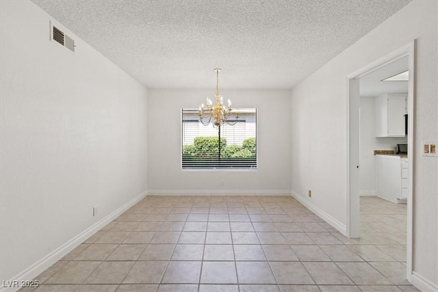 2480 Domingo St, Las Vegas, NV 89121 - spare room with a chandelier, light tile patterned flooring, and a textured ceiling