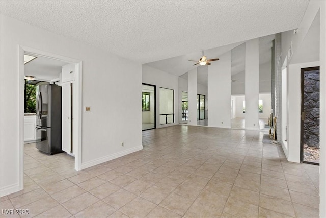 2480 Domingo St, Las Vegas, NV 89121 - spare room featuring ceiling fan, healthy amount of natural light, a textured ceiling, light tile patterned flooring, and lofted ceiling