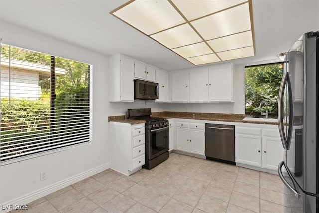 2480 Domingo St, Las Vegas, NV 89121 - kitchen with appliances with stainless steel finishes, a sink, plenty of natural light, and white cabinets