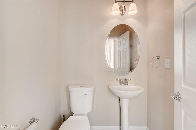 6402 Parrot Ridge Ct, Las Vegas, NV 89139 - half bathroom with toilet, baseboards, and a sink