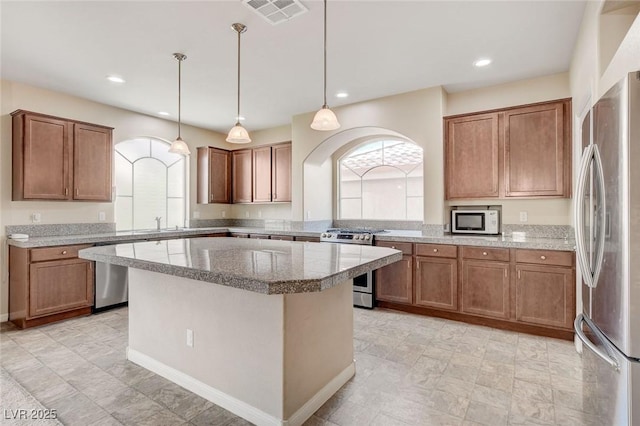 6402 Parrot Ridge Ct, Las Vegas, NV 89139 - kitchen with appliances with stainless steel finishes, arched walkways, brown cabinetry, and recessed lighting
