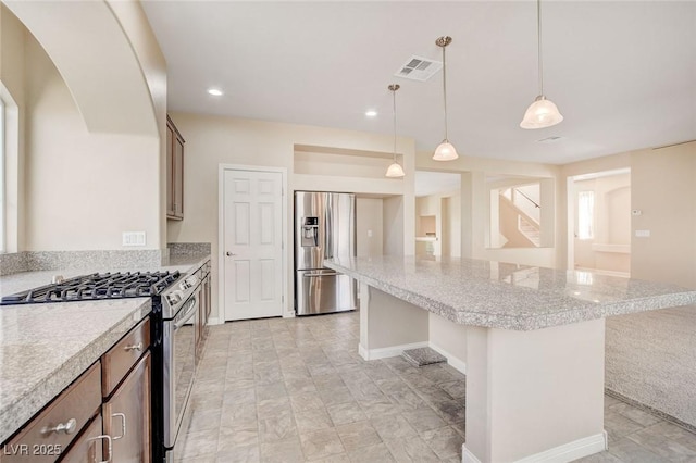 6402 Parrot Ridge Ct, Las Vegas, NV 89139 - kitchen featuring appliances with stainless steel finishes, a kitchen island, a kitchen breakfast bar, hanging light fixtures, and recessed lighting