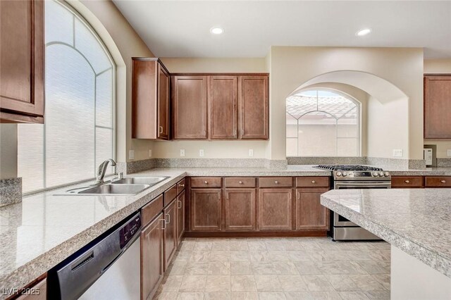 6402 Parrot Ridge Ct, Las Vegas, NV 89139 - kitchen with stainless steel appliances, a sink, light countertops, recessed lighting, and brown cabinetry