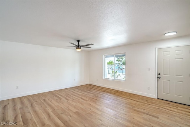 1600 E Mcdonald Ave, North Las Vegas, NV 89030 - unfurnished room with a ceiling fan, light wood-style floors, and baseboards