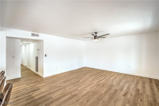 1600 E Mcdonald Ave, North Las Vegas, NV 89030 - spare room featuring a ceiling fan, light wood-style floors, and baseboards