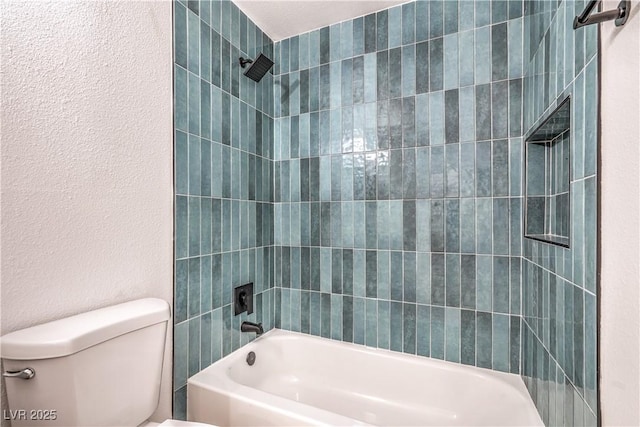 1600 E Mcdonald Ave, North Las Vegas, NV 89030 - bathroom with toilet, bathing tub / shower combination, and a textured wall