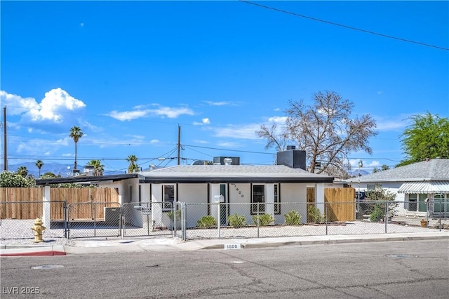 1600 E Mcdonald Ave, North Las Vegas, NV 89030 - ranch-style home with a fenced front yard, a gate, an attached carport, covered porch, and stucco siding
