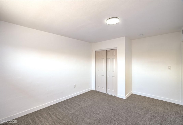 1600 E Mcdonald Ave, North Las Vegas, NV 89030 - unfurnished bedroom with dark colored carpet, baseboards, and a closet