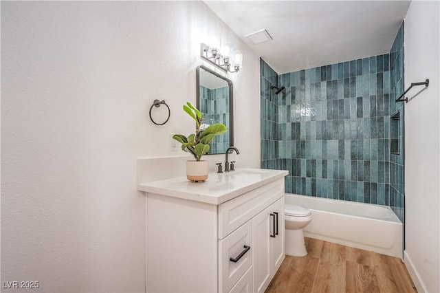 1600 E Mcdonald Ave, North Las Vegas, NV 89030 - bathroom with toilet, vanity, shower / washtub combination, and wood finished floors