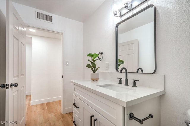 1600 E Mcdonald Ave, North Las Vegas, NV 89030 - bathroom featuring vanity, wood finished floors, and baseboards