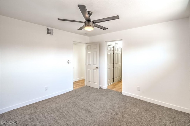 1600 E Mcdonald Ave, North Las Vegas, NV 89030 - unfurnished bedroom with light colored carpet, baseboards, and a ceiling fan