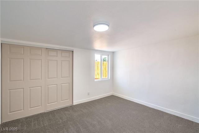 1600 E Mcdonald Ave, North Las Vegas, NV 89030 - unfurnished bedroom featuring dark colored carpet, baseboards, and a closet
