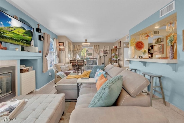 7950 W Flamingo Rd Unit 1003, Las Vegas, NV 89147 - living room with baseboards and a glass covered fireplace