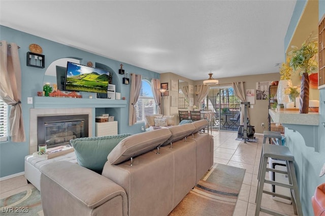 7950 W Flamingo Rd Unit 1003, Las Vegas, NV 89147 - tiled living room featuring plenty of natural light and a tile fireplace