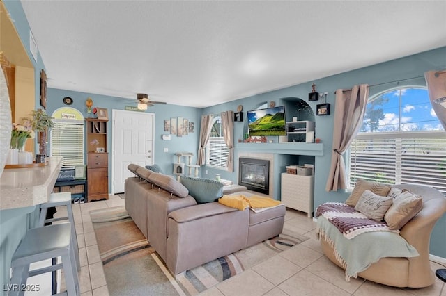 7950 W Flamingo Rd Unit 1003, Las Vegas, NV 89147 - living room with light tile patterned floors, plenty of natural light, and a ceiling fan