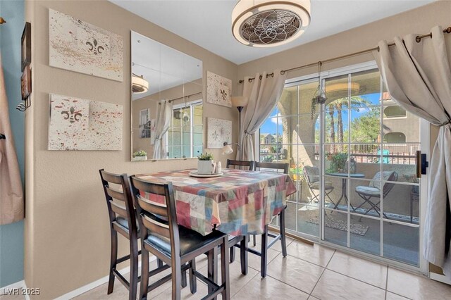 7950 W Flamingo Rd Unit 1003, Las Vegas, NV 89147 - tiled dining room featuring baseboards