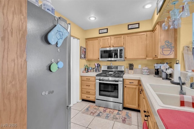 7950 W Flamingo Rd Unit 1003, Las Vegas, NV 89147 - kitchen featuring appliances with stainless steel finishes, light brown cabinetry, light countertops, and light tile patterned flooring