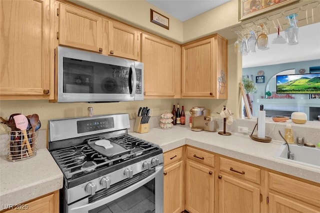 7950 W Flamingo Rd Unit 1003, Las Vegas, NV 89147 - kitchen featuring appliances with stainless steel finishes, light brown cabinets, light countertops, and tile patterned flooring