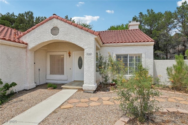 3201 Beacon Shores Cir, Las Vegas, NV 89117 - view of front of house featuring a chimney, a tile roof, and stucco siding
