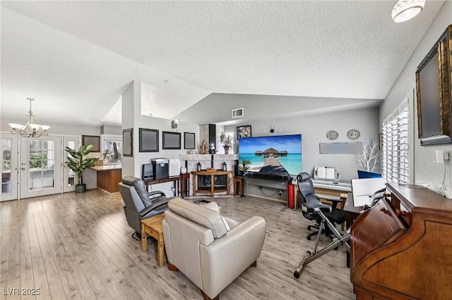 3201 Beacon Shores Cir, Las Vegas, NV 89117 - living area with lofted ceiling, a chandelier, a textured ceiling, plenty of natural light, and a desk