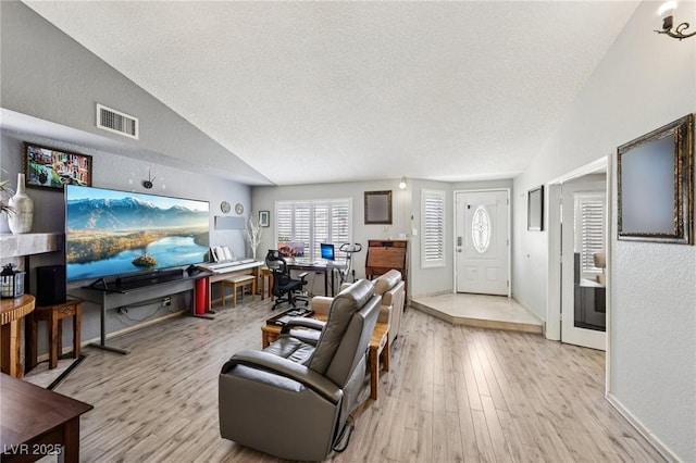 3201 Beacon Shores Cir, Las Vegas, NV 89117 - living room with a textured ceiling, wood finished floors, a desk, lofted ceiling, and a textured wall