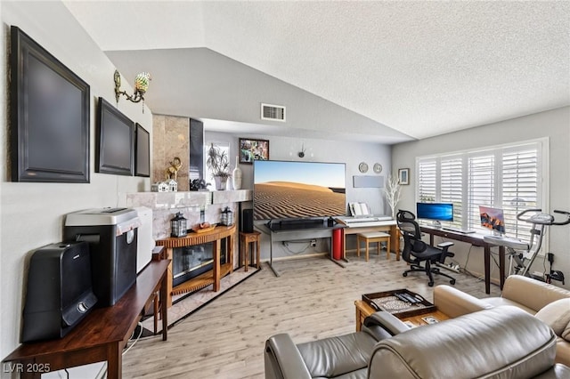 3201 Beacon Shores Cir, Las Vegas, NV 89117 - living room featuring vaulted ceiling, light wood finished floors, a desk, and a textured ceiling