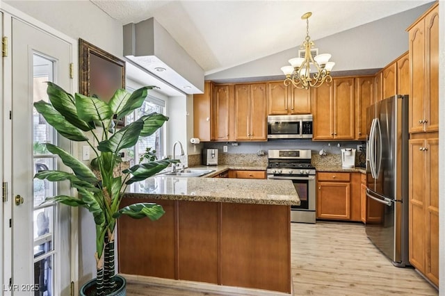 3201 Beacon Shores Cir, Las Vegas, NV 89117 - kitchen with appliances with stainless steel finishes, a sink, a peninsula, vaulted ceiling, and light stone counters