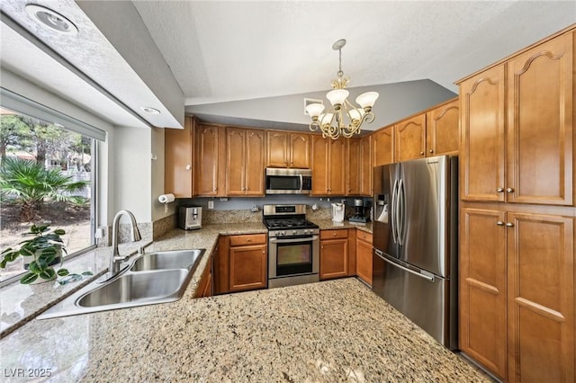 3201 Beacon Shores Cir, Las Vegas, NV 89117 - kitchen with stainless steel appliances, a sink, a chandelier, vaulted ceiling, and brown cabinetry