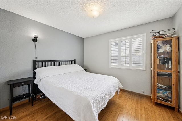 3201 Beacon Shores Cir, Las Vegas, NV 89117 - bedroom featuring a textured ceiling, wood finished floors, and baseboards