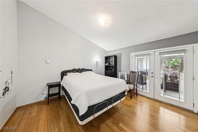 3201 Beacon Shores Cir, Las Vegas, NV 89117 - bedroom featuring a textured ceiling, french doors, vaulted ceiling, access to outside, and wood finished floors