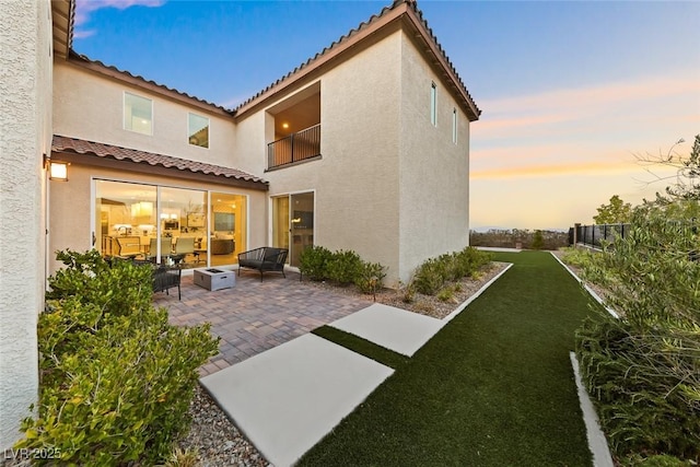 4702 Amazing View St, Las Vegas, NV 89129 - rear view of house with a tile roof, a patio, stucco siding, and a balcony